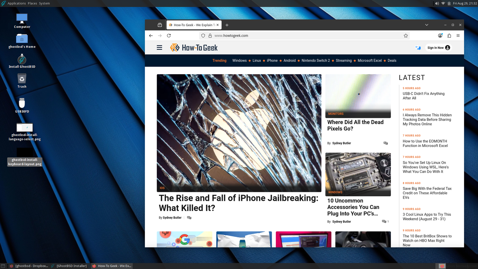 GhostBSD live desktop with Firefox open to the HTG homepage.
